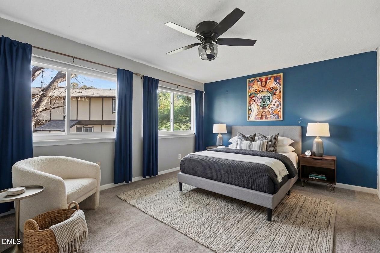 4271 Lake Ridge Drive Raleigh, NC 27604 - Photo 20 of 36 a bedroom with a bed and a chandelier