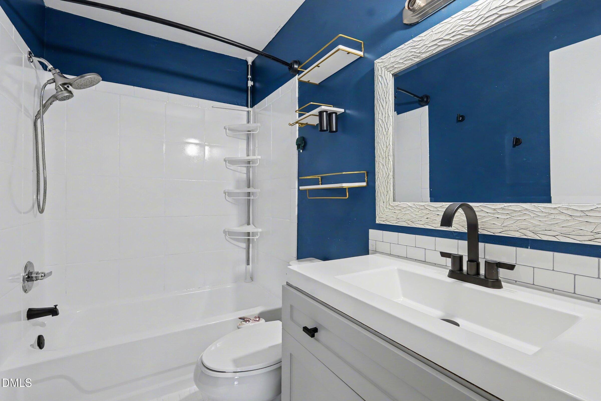 4271 Lake Ridge Drive Raleigh, NC 27604 - Photo 28 of 36 a bathroom with a sink a toilet and shower