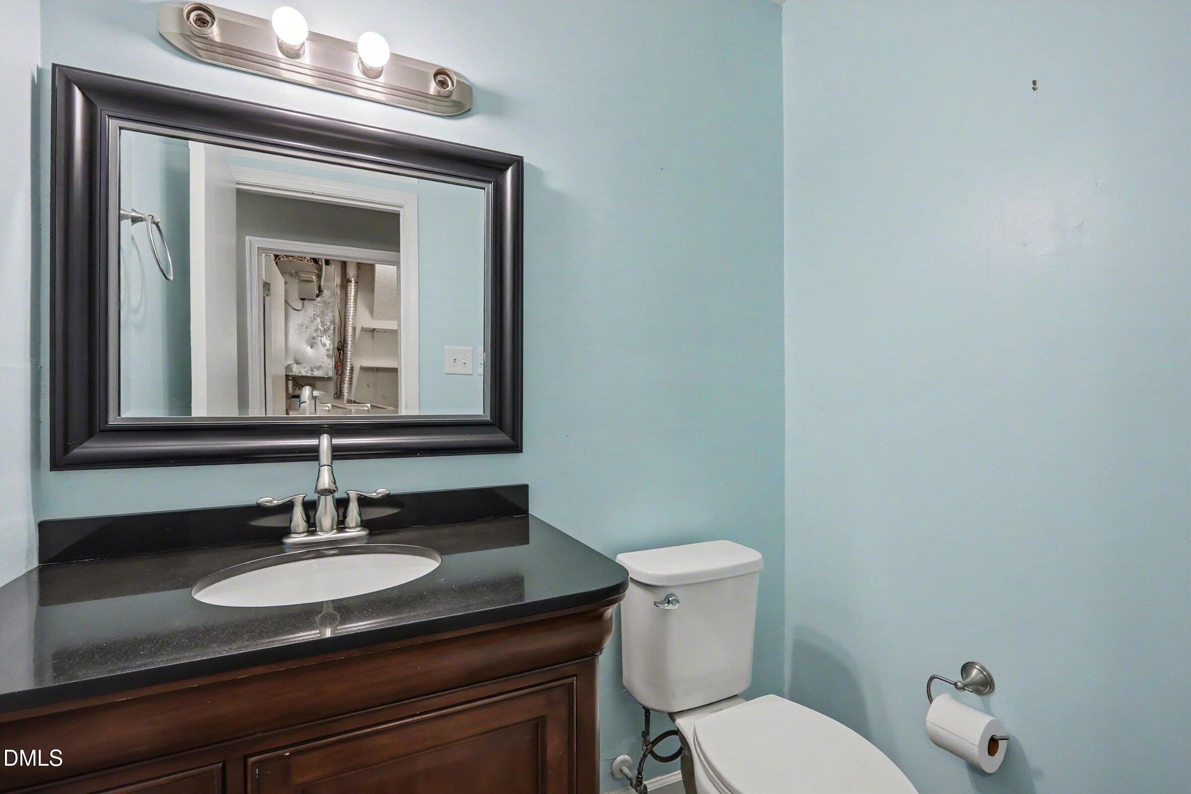 4271 Lake Ridge Drive Raleigh, NC 27604 - Photo 30 of 36 a bathroom with a toilet sink and mirror