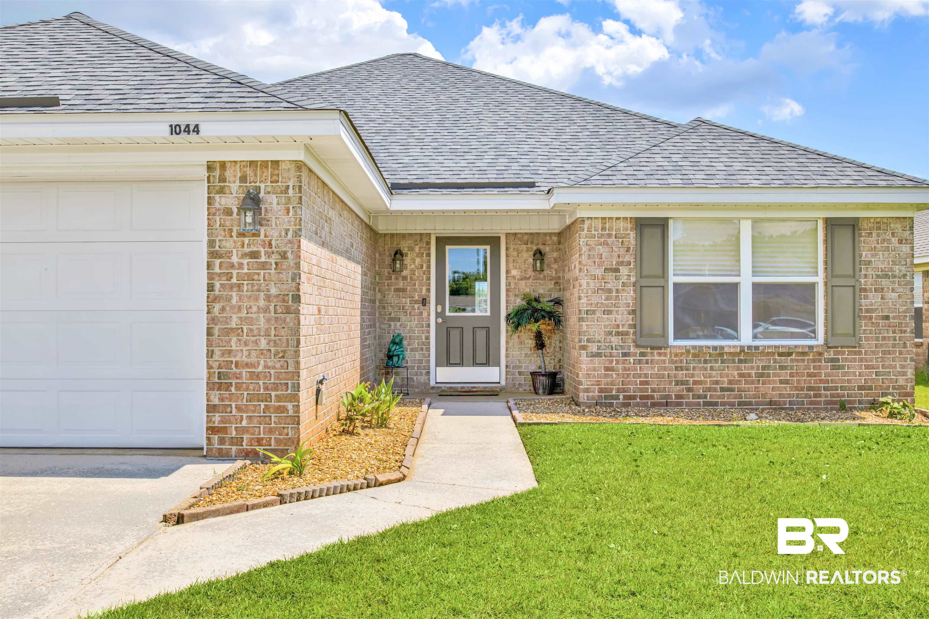 1044 Amazon Drive Foley, AL 36535 - Photo 2 of 29 View of front of house featuring a garage and a front yard