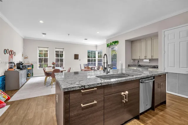 a view of center island wooden floor and kitchen