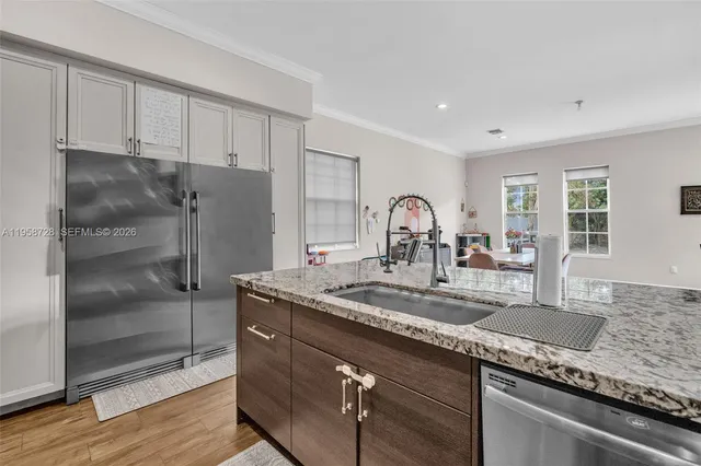 a kitchen with granite countertop a sink and cabinets
