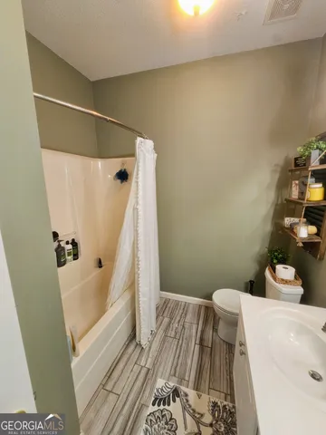 a bedroom with a bed and cabinets