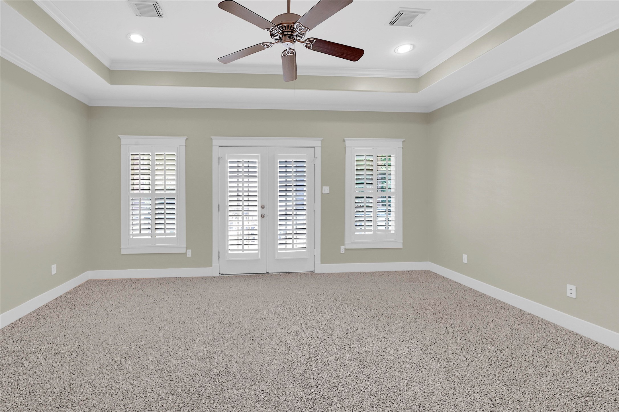 4418 Edsee Street Houston, TX 77009 - Photo 14 of 28 Check out this absolutely stunning primary retreat, complete with tray ceilings, recessed lighting, and a wall of windows and french doors leading to your balcony.