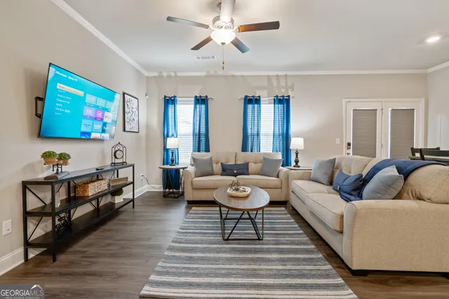 a living room with furniture and a flat screen tv