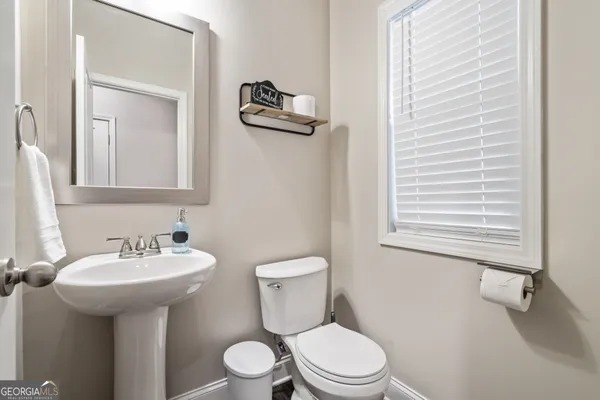 a bathroom with a sink a mirror and a toilet