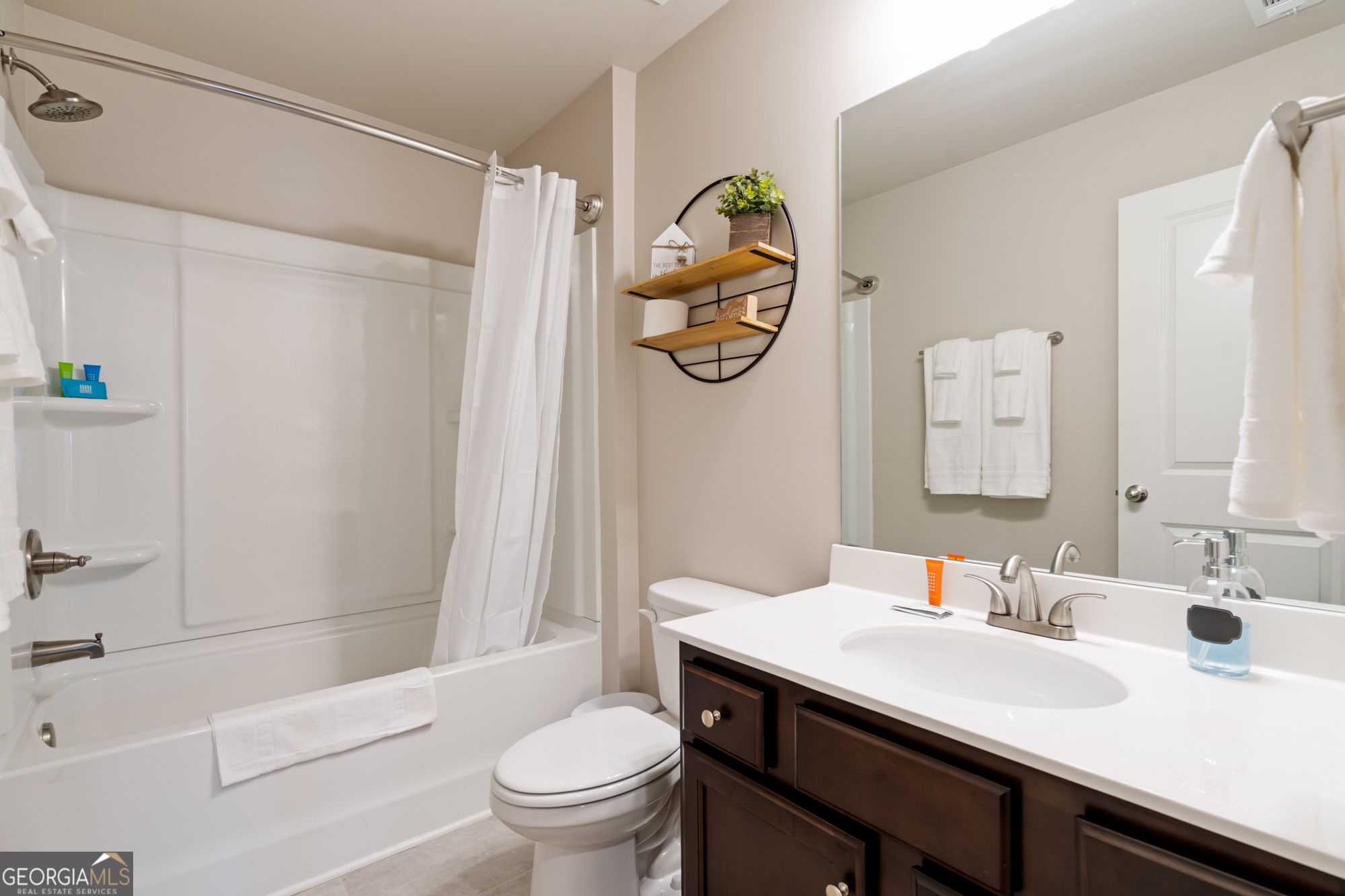 2029 Pinnacle Way Norcross, GA 30071 - Photo 19 of 30 a bathroom with a sink a toilet and a mirror