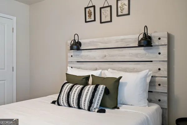 a bedroom with a bed and lamp