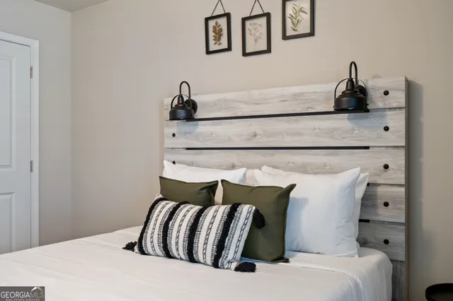 a bedroom with a bed and lamp