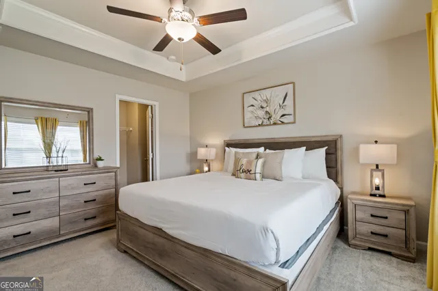 a bedroom with a bed and a dresser