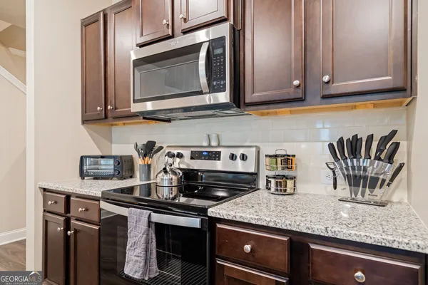 a kitchen with granite countertop a sink and cabinets