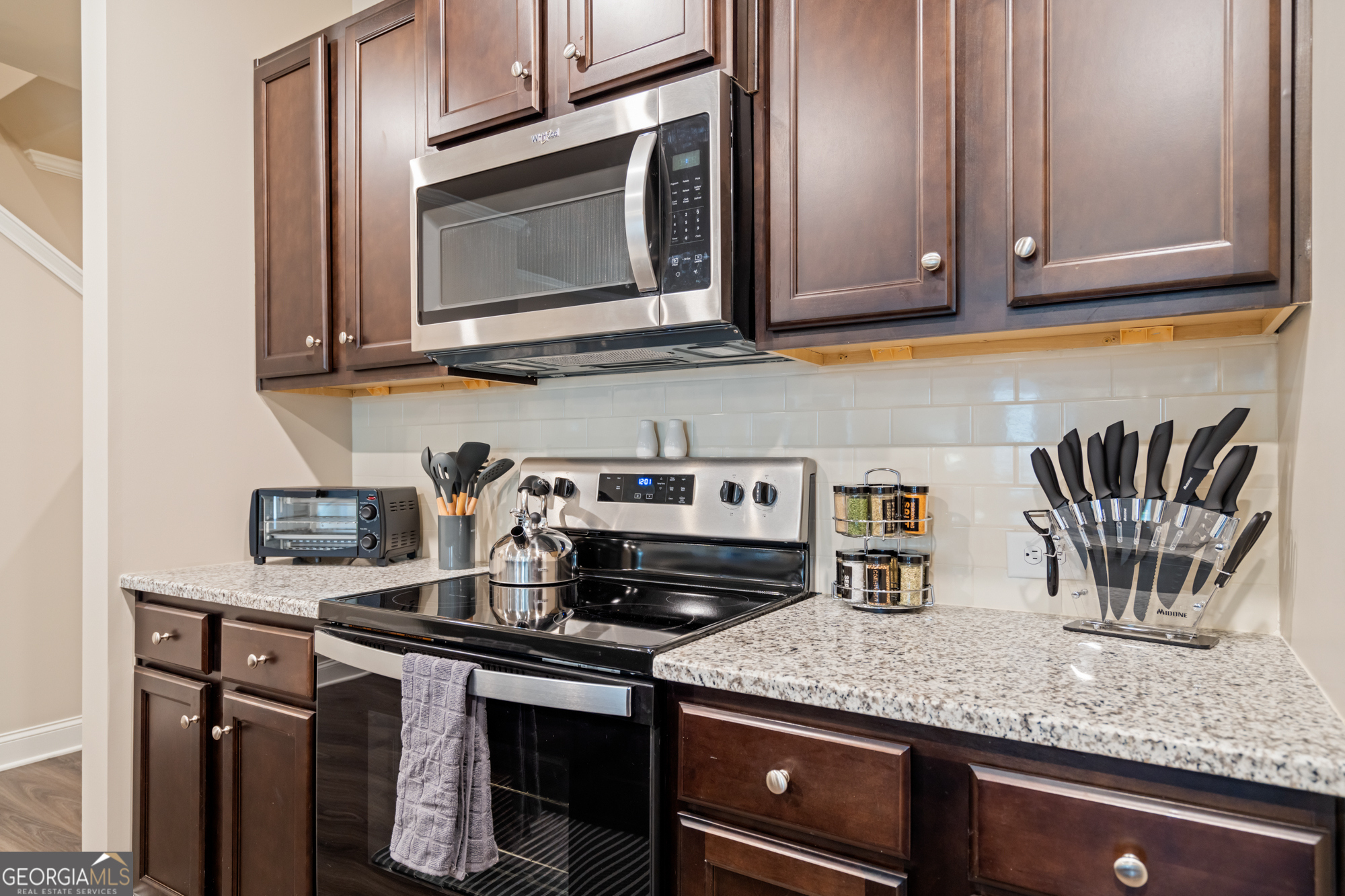 2029 Pinnacle Way Norcross, GA 30071 - Photo 6 of 30 a kitchen with granite countertop a sink and cabinets