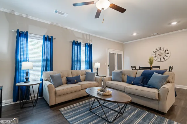 a living room with furniture and wooden floor