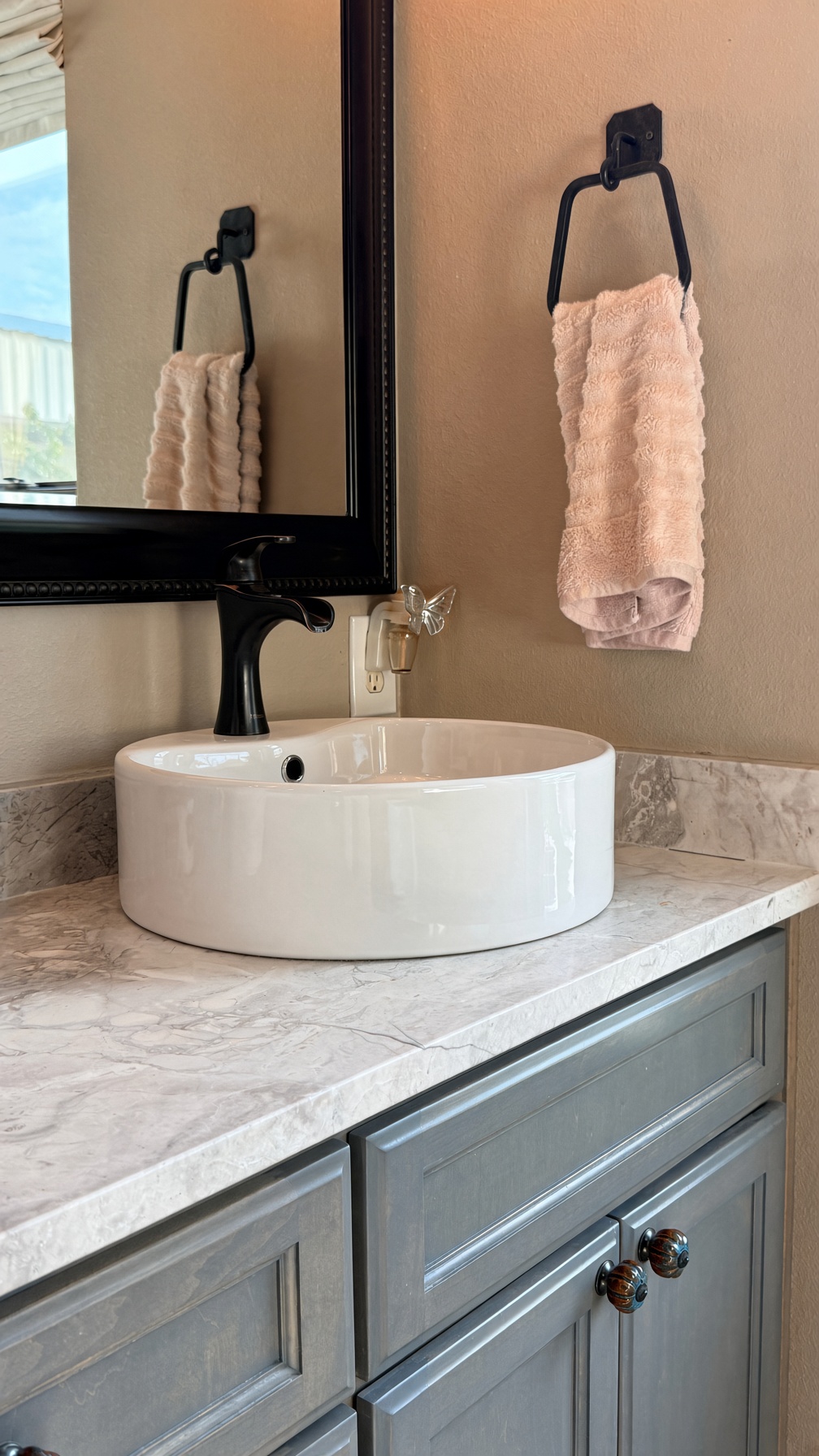 19005 White Rim Trail Jonestown, TX 78645 - Photo 21 of 39 A stylish vessel sink rests atop elegant stone counters in this modern vanity area.