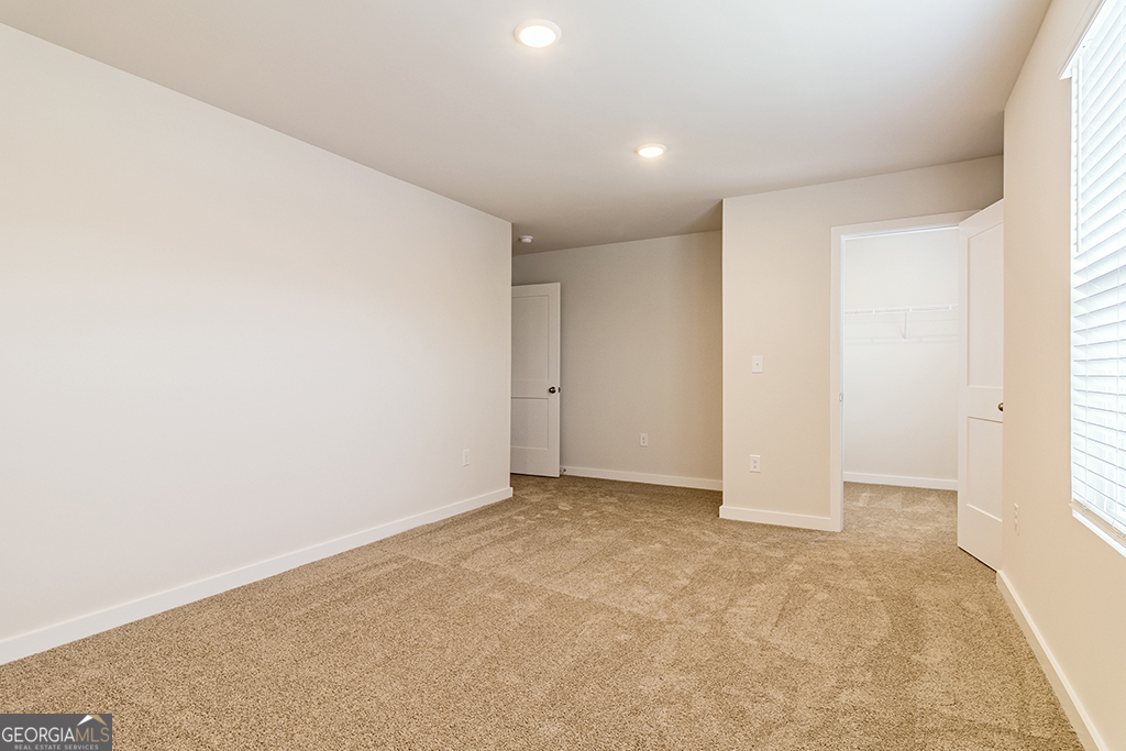 337 Jarrett Street Fairburn, GA 30213 - Photo 18 of 32 an empty room with windows