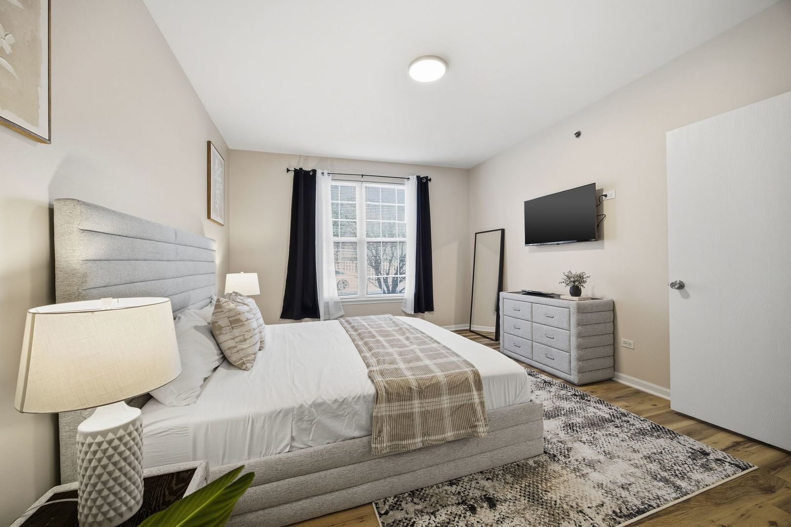 8232 Concord Lane, Unit B Justice, IL 60458 - Photo 19 of 32 a bedroom with a bed and flat screen tv