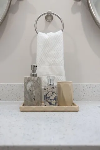 a bathroom with a granite countertop sink a toilet and a mirror