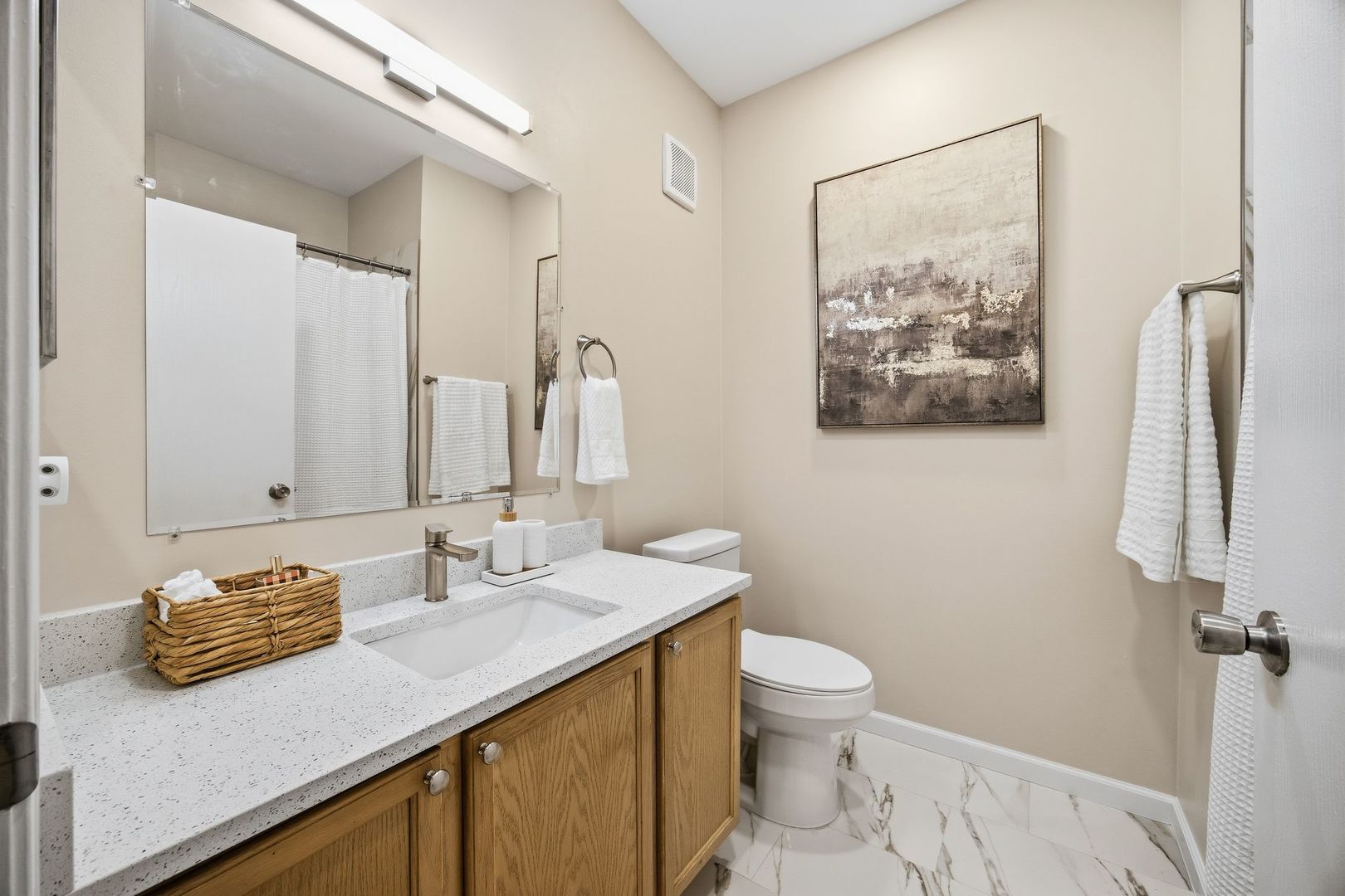 8232 Concord Lane, Unit B Justice, IL 60458 - Photo 30 of 32 a bathroom with a granite countertop sink a toilet and a mirror