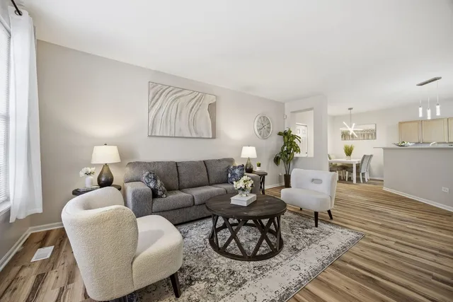 a living room with furniture and wooden floor