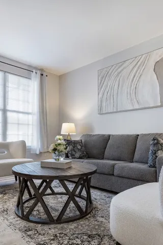 a living room with furniture and wooden floor