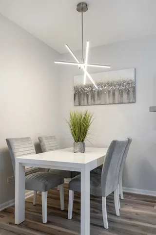 a view of a dining room with furniture and chandelier