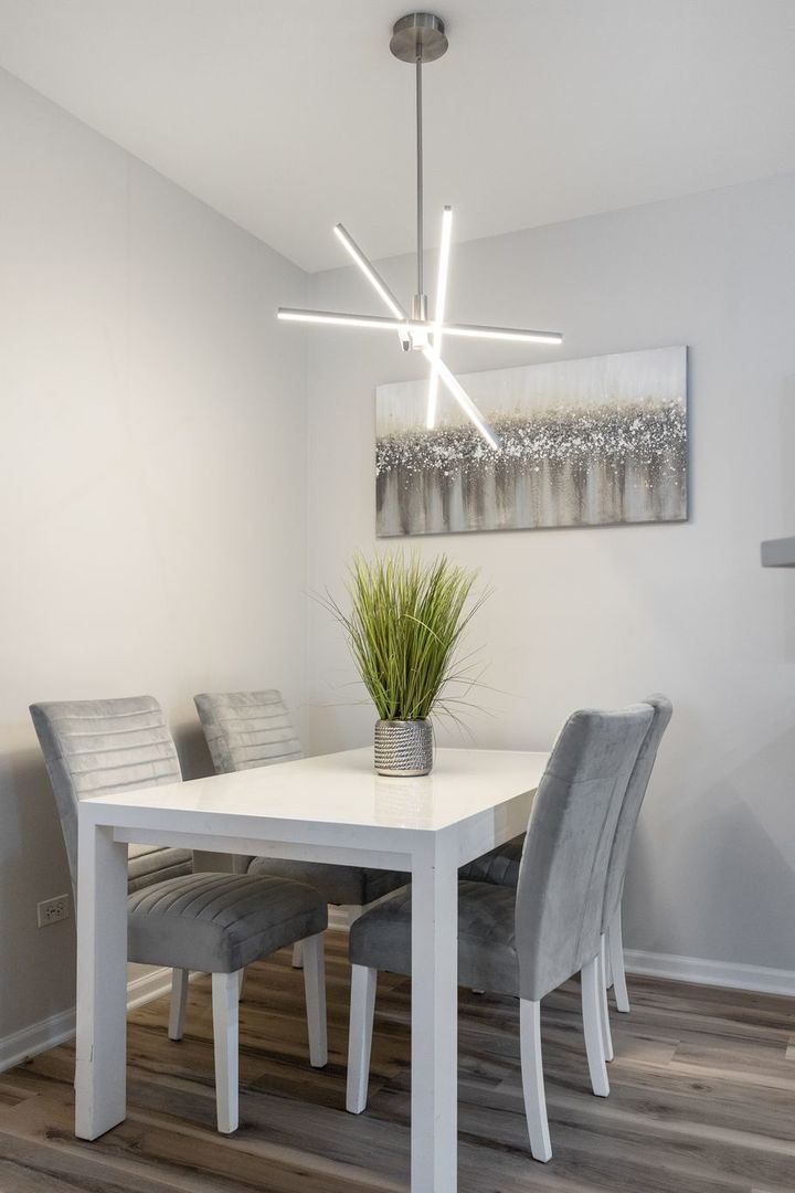 8232 Concord Lane, Unit B Justice, IL 60458 - Photo 9 of 32 a view of a dining room with furniture and chandelier