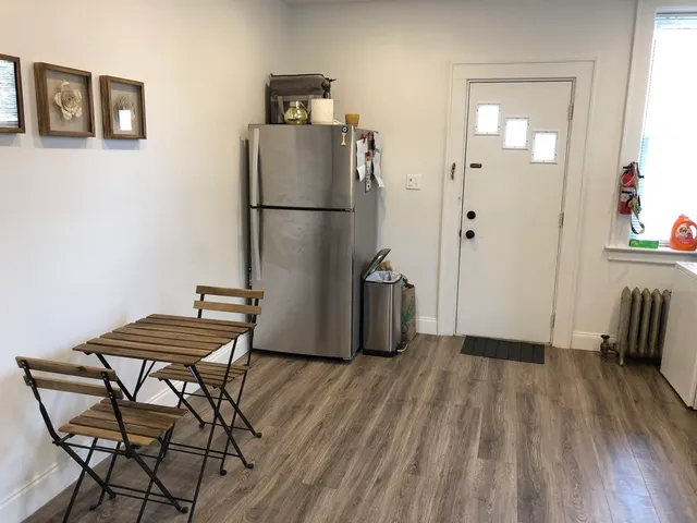 a view of a room with furniture and wooden floor