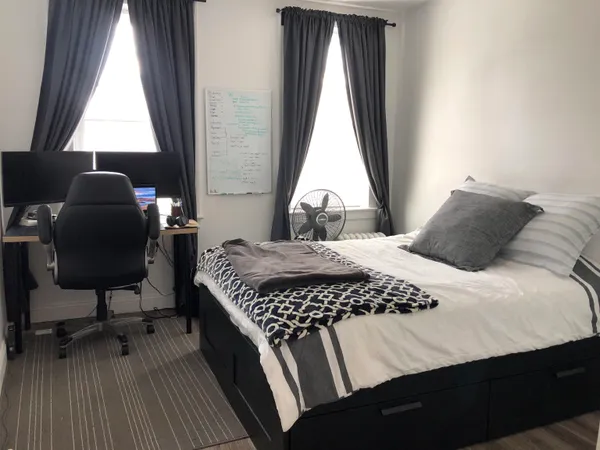 a bedroom with a bed and a window