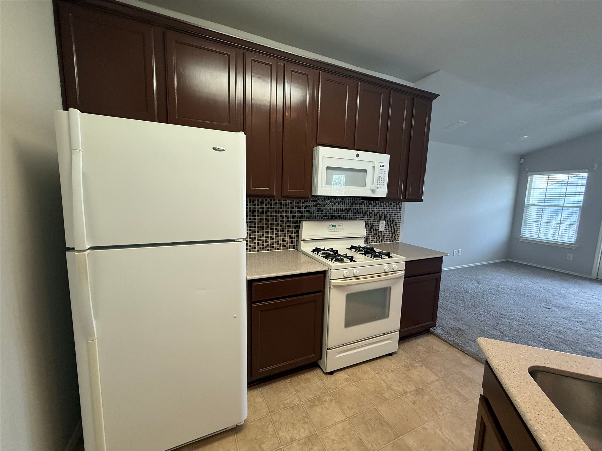 1900 Scofield Ridge Parkway, Unit 4701 Austin, TX 78727 - Photo 2 of 27 Functional kitchen with ample cabinet space, an efficient layout, and durable tiled flooring.