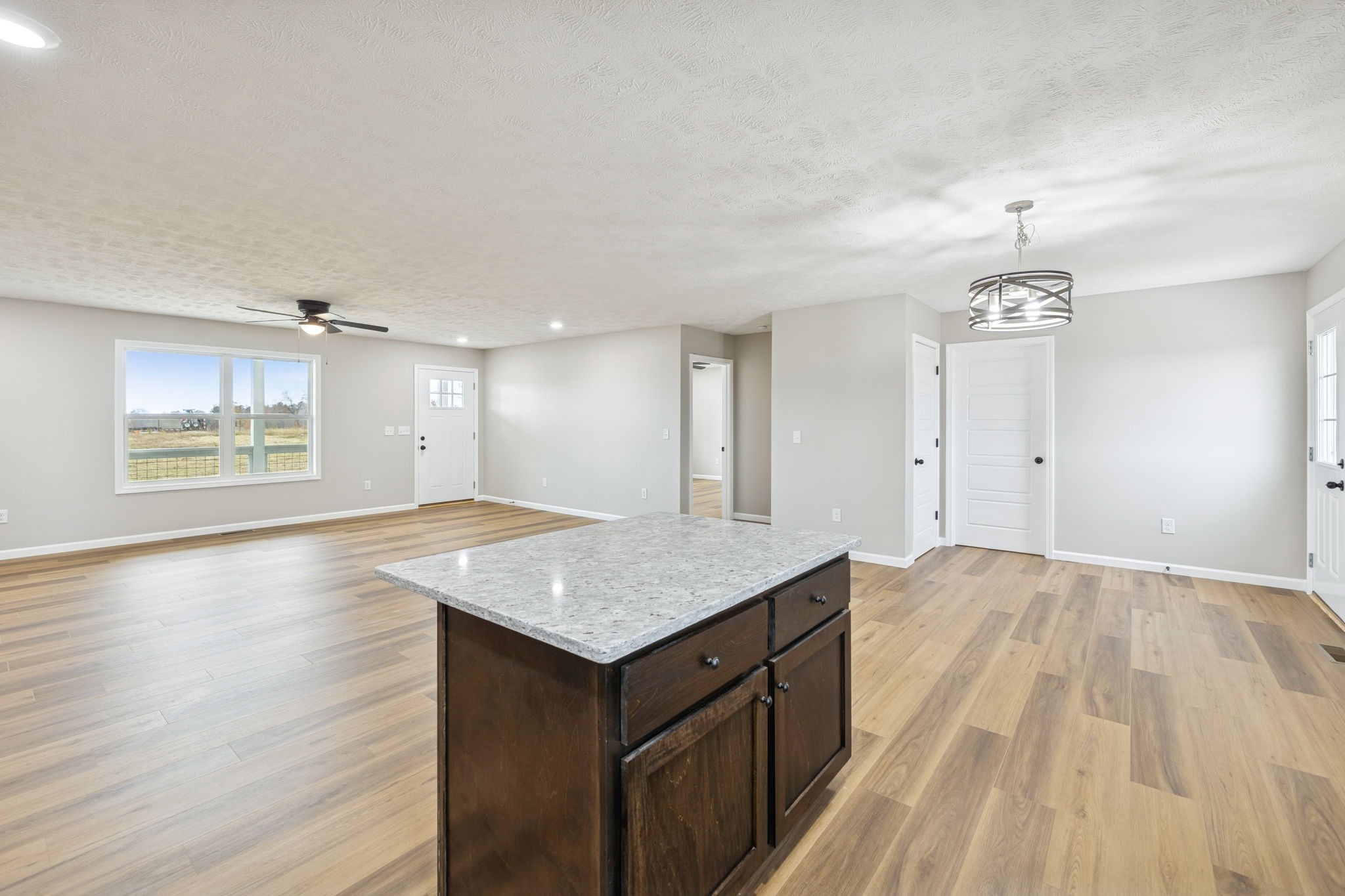 2649 Oak Knob Road Lafayette, TN 37083 - Photo 11 of 34 an empty room with wooden floor cabinet and windows