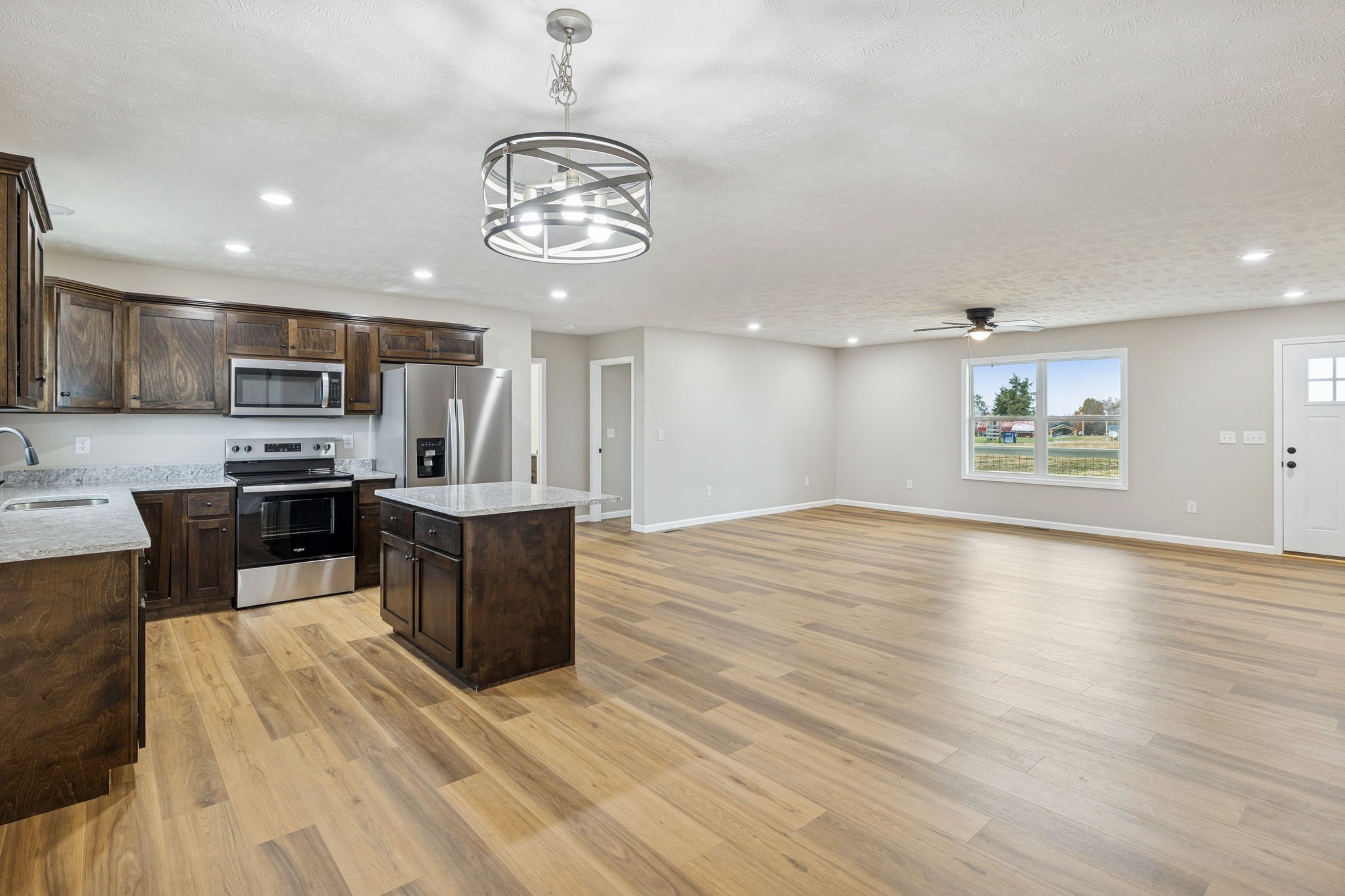 2649 Oak Knob Road Lafayette, TN 37083 - Photo 13 of 34 a large kitchen with stainless steel appliances a large counter top a stove and a wooden floors