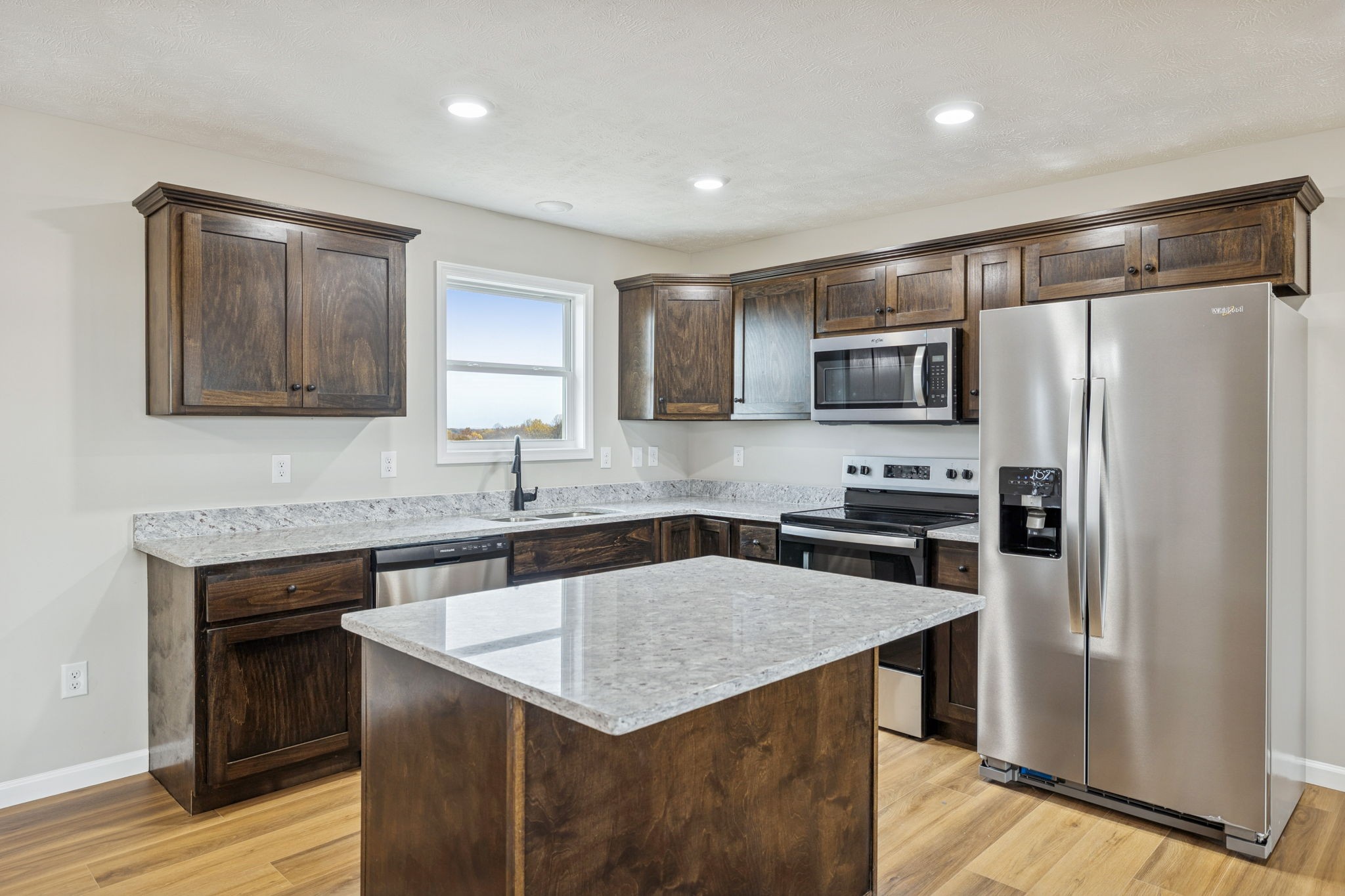 2649 Oak Knob Road Lafayette, TN 37083 - Photo 9 of 34 a kitchen with kitchen island a sink stove and refrigerator