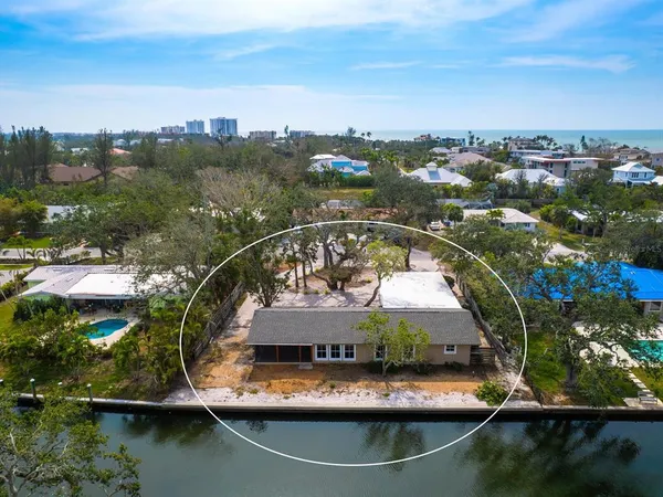 an aerial view of house with yard swimming pool and lake view