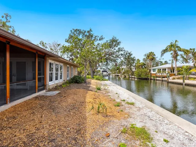 a view of a house with swimming pool next to a yard
