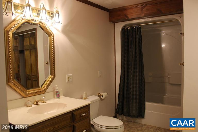 5224 Shelby Road Rochelle, VA 22738 - Photo 14 of 25 a bathroom with a sink toilet and shower
