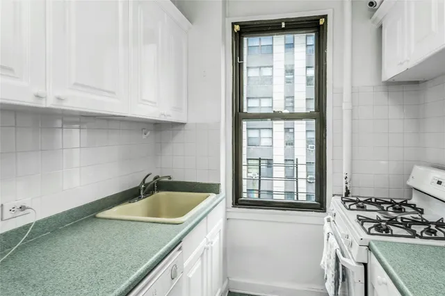 a kitchen that has a sink and a stove