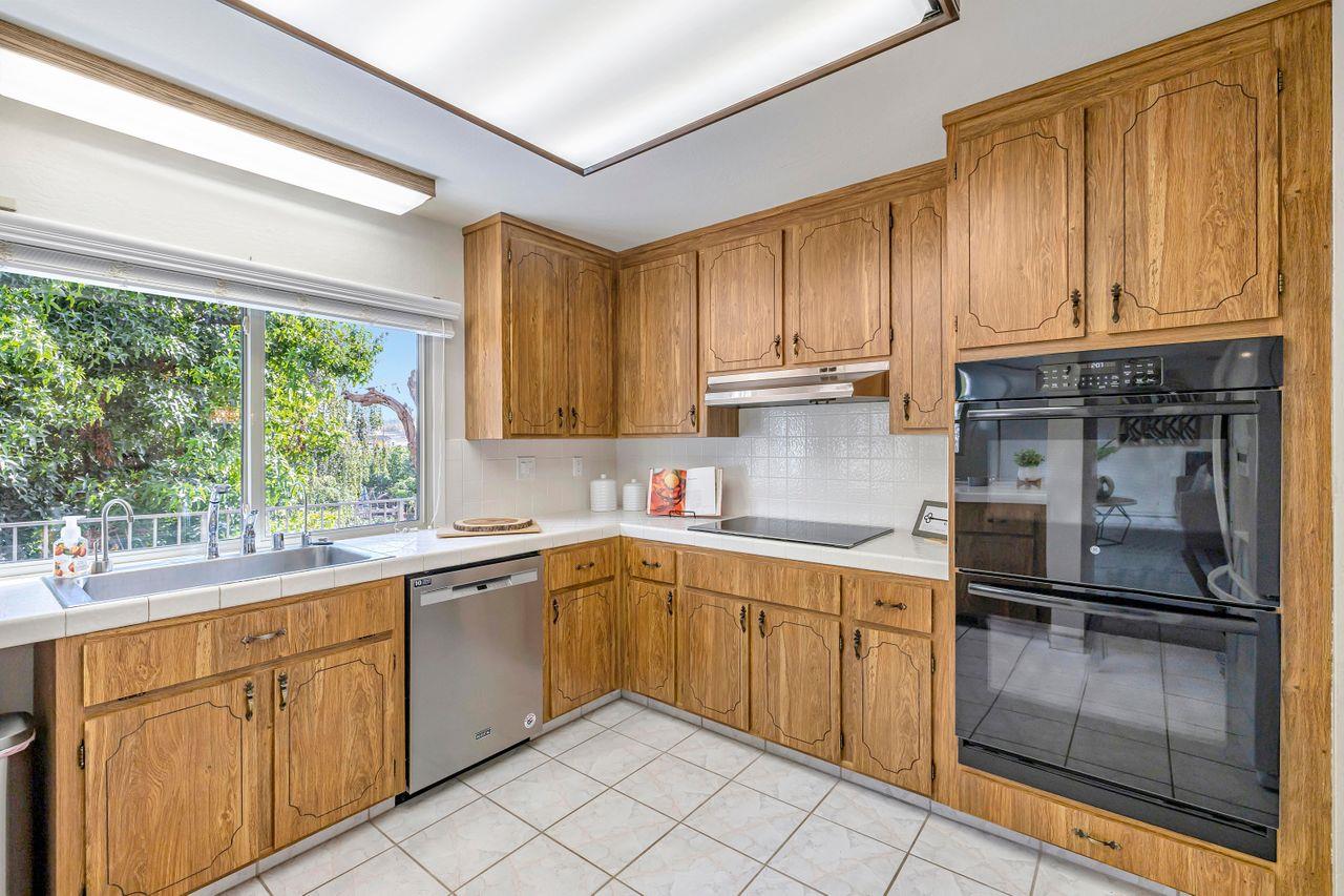 431 Green Hills Drive Millbrae, CA 94030 - Photo 14 of 50 a kitchen with a sink window and cabinets