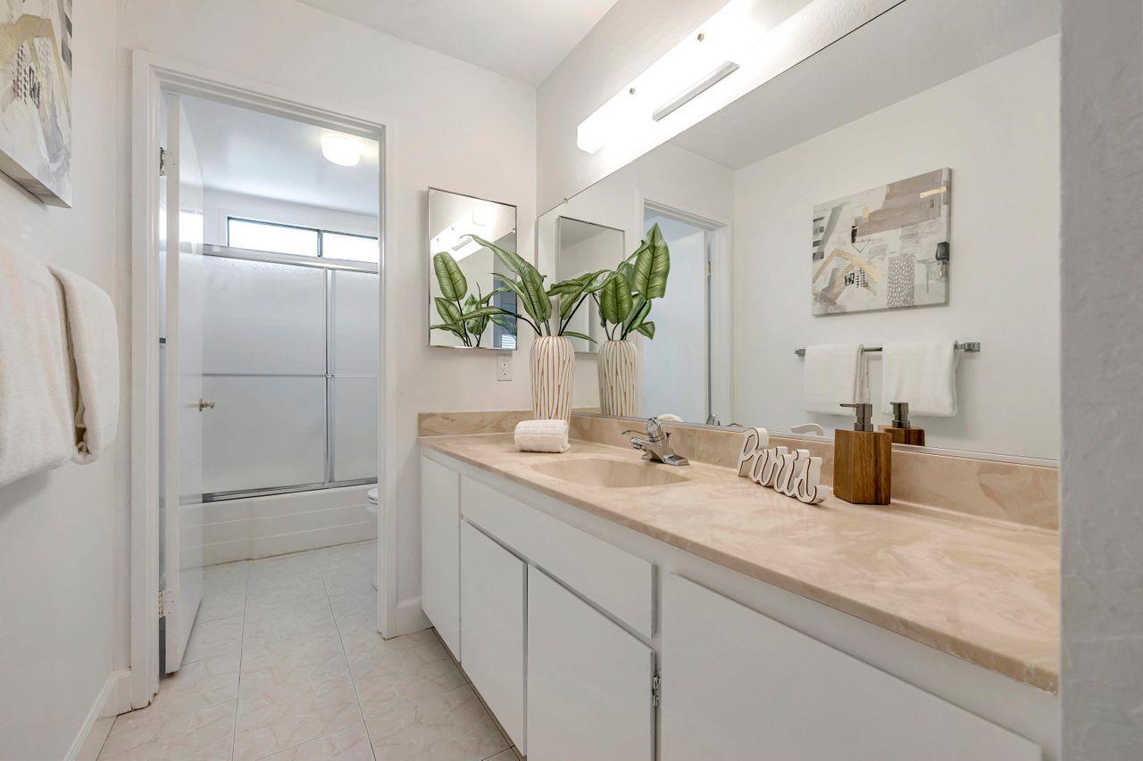 431 Green Hills Drive Millbrae, CA 94030 - Photo 33 of 50 a bathroom with a granite countertop sink a mirror and shower