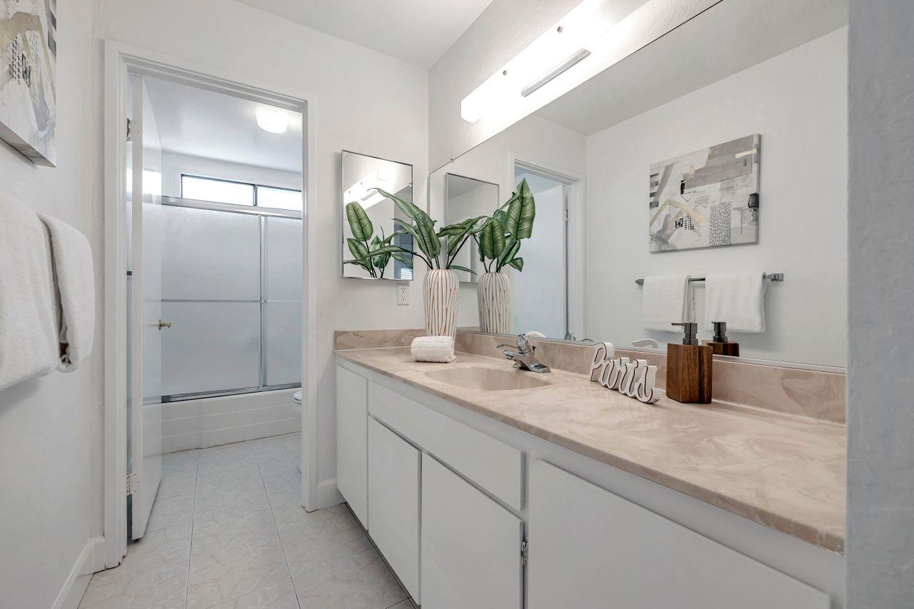 431 Green Hills Drive Millbrae, CA 94030 - Photo 34 of 50 a bathroom with a granite countertop sink a mirror and shower