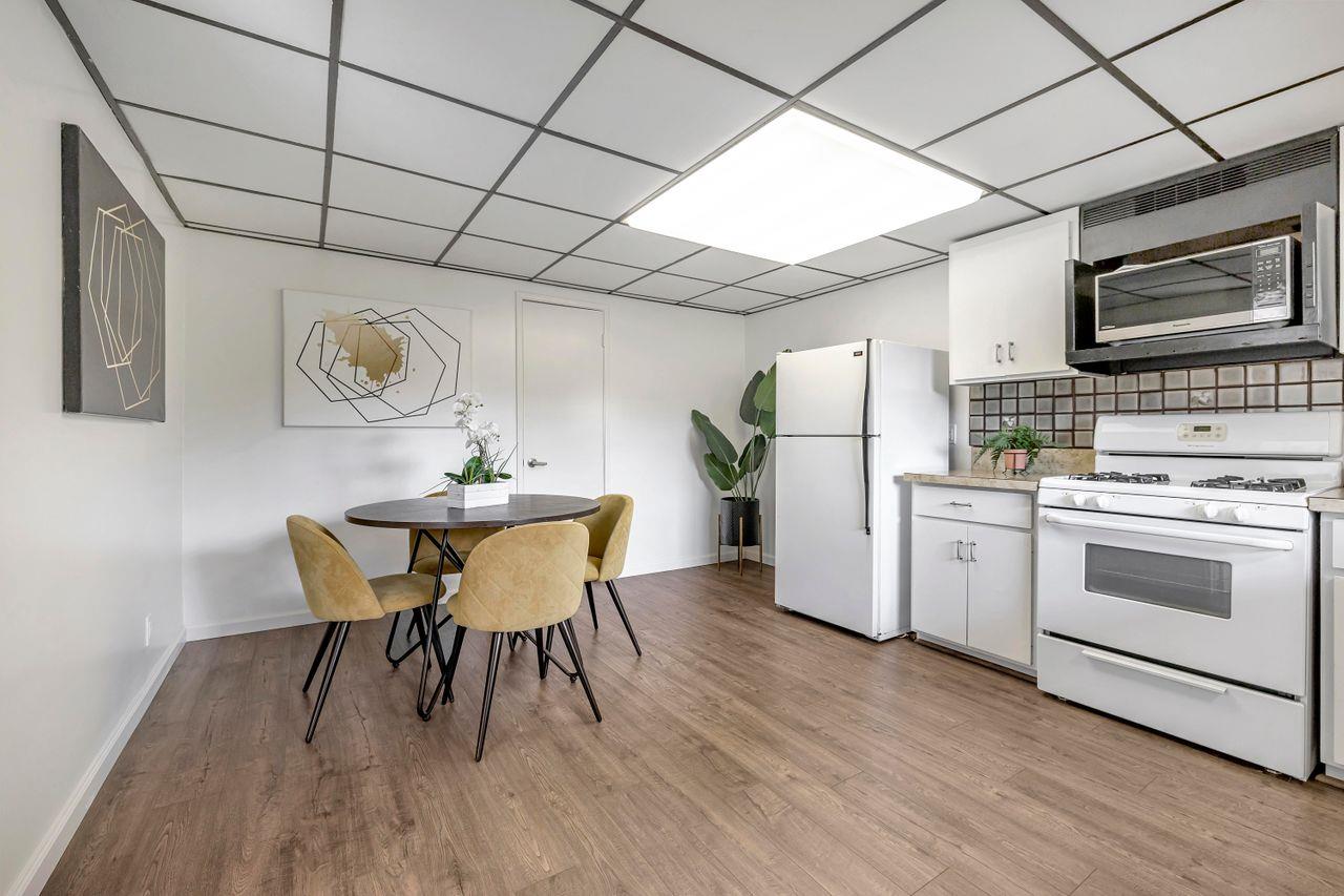 431 Green Hills Drive Millbrae, CA 94030 - Photo 37 of 50 a kitchen with a dining table chairs refrigerator and cabinets