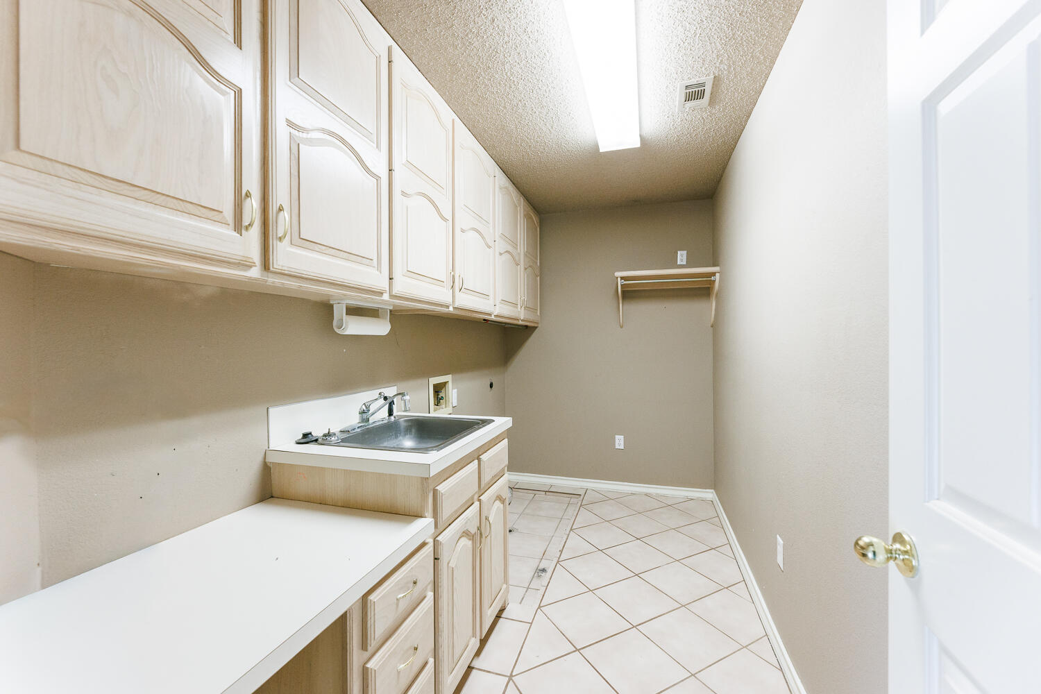 206 Collins Avenue Sundown, TX 79372 - Photo 56 of 82 a bathroom with a sink a vanity and a window