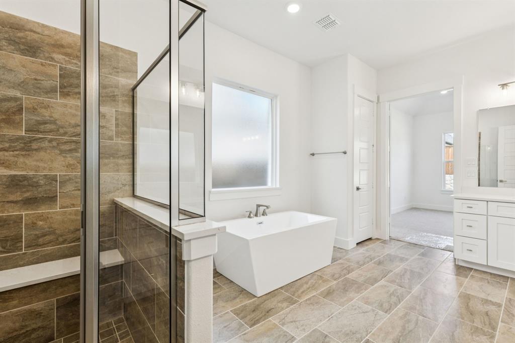 1608 Angus Trail Van Alstyne, TX 75495 - Photo 10 of 24 a spacious bathroom with a double vanity sink a mirror and a shower