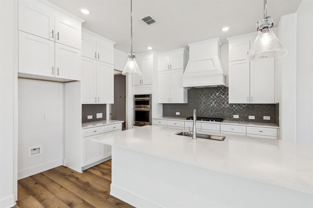 1608 Angus Trail Van Alstyne, TX 75495 - Photo 2 of 24 a kitchen with kitchen island a stove a refrigerator a sink a center island and chairs