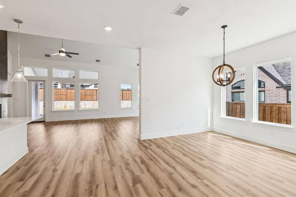 1608 Angus Trail Van Alstyne, TX 75495 - Photo 4 of 24 a view of an empty room with wooden floor and a window