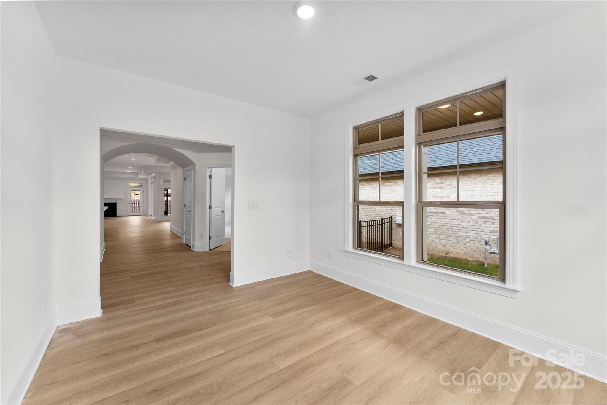 415 Newstyle Way Gastonia, NC 28056 - Photo 21 of 26 a view of an empty room with wooden floor and a window