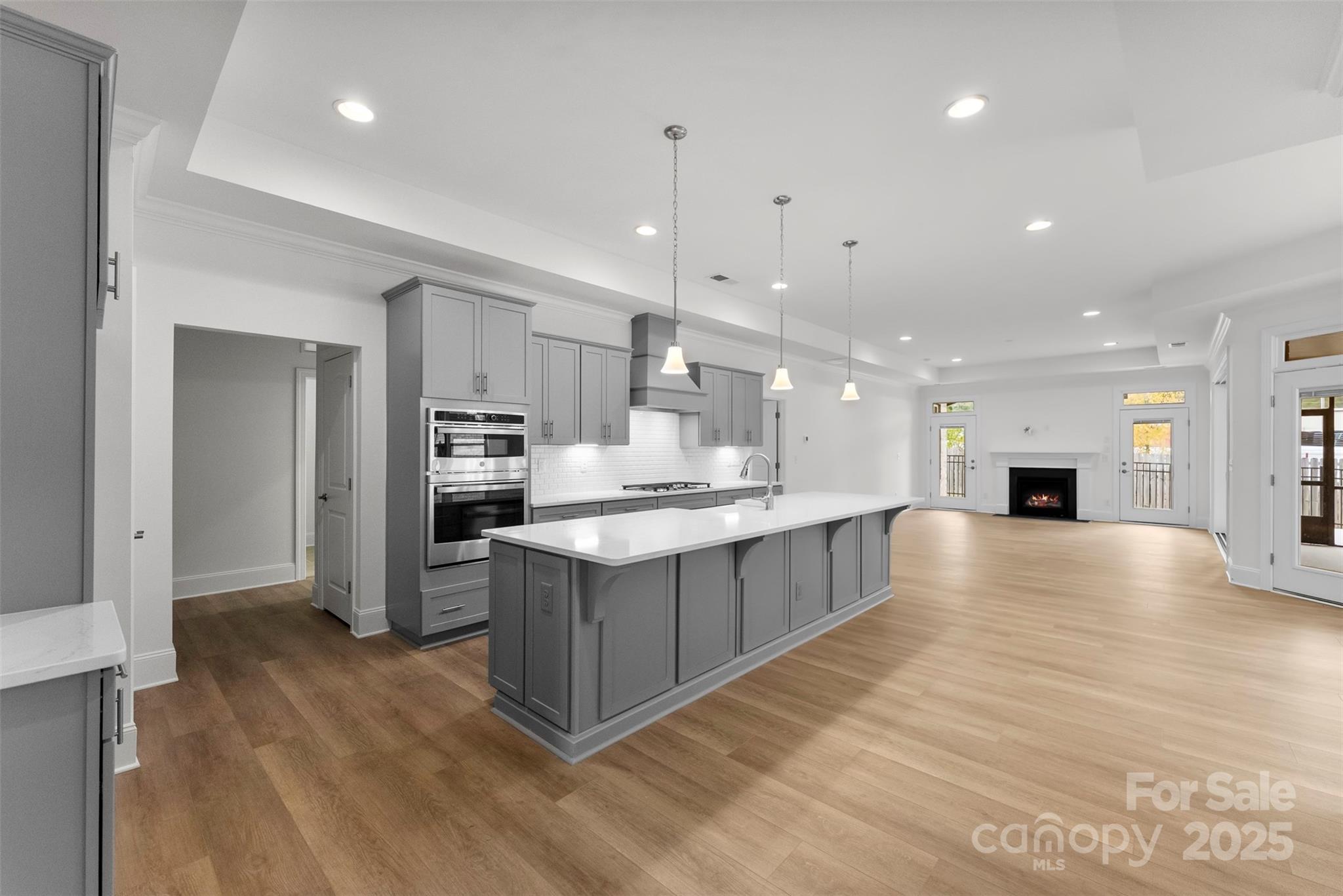 415 Newstyle Way Gastonia, NC 28056 - Photo 3 of 26 a large kitchen with kitchen island a sink stainless steel appliances and cabinets
