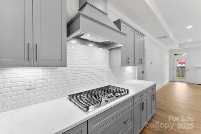 a kitchen with granite countertop a stove and a sink