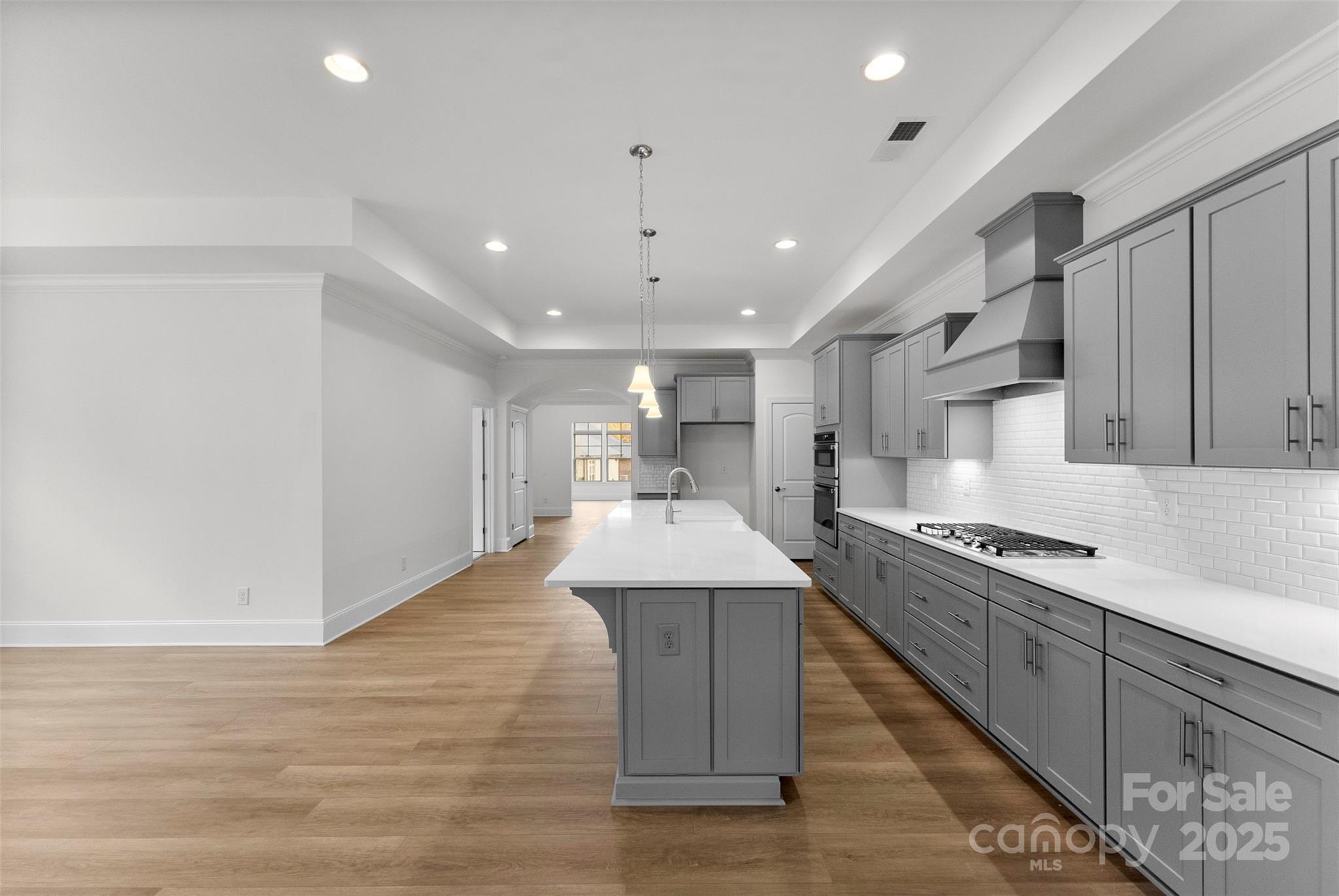 415 Newstyle Way Gastonia, NC 28056 - Photo 6 of 26 a kitchen with stainless steel appliances granite countertop a sink stove and wooden floor