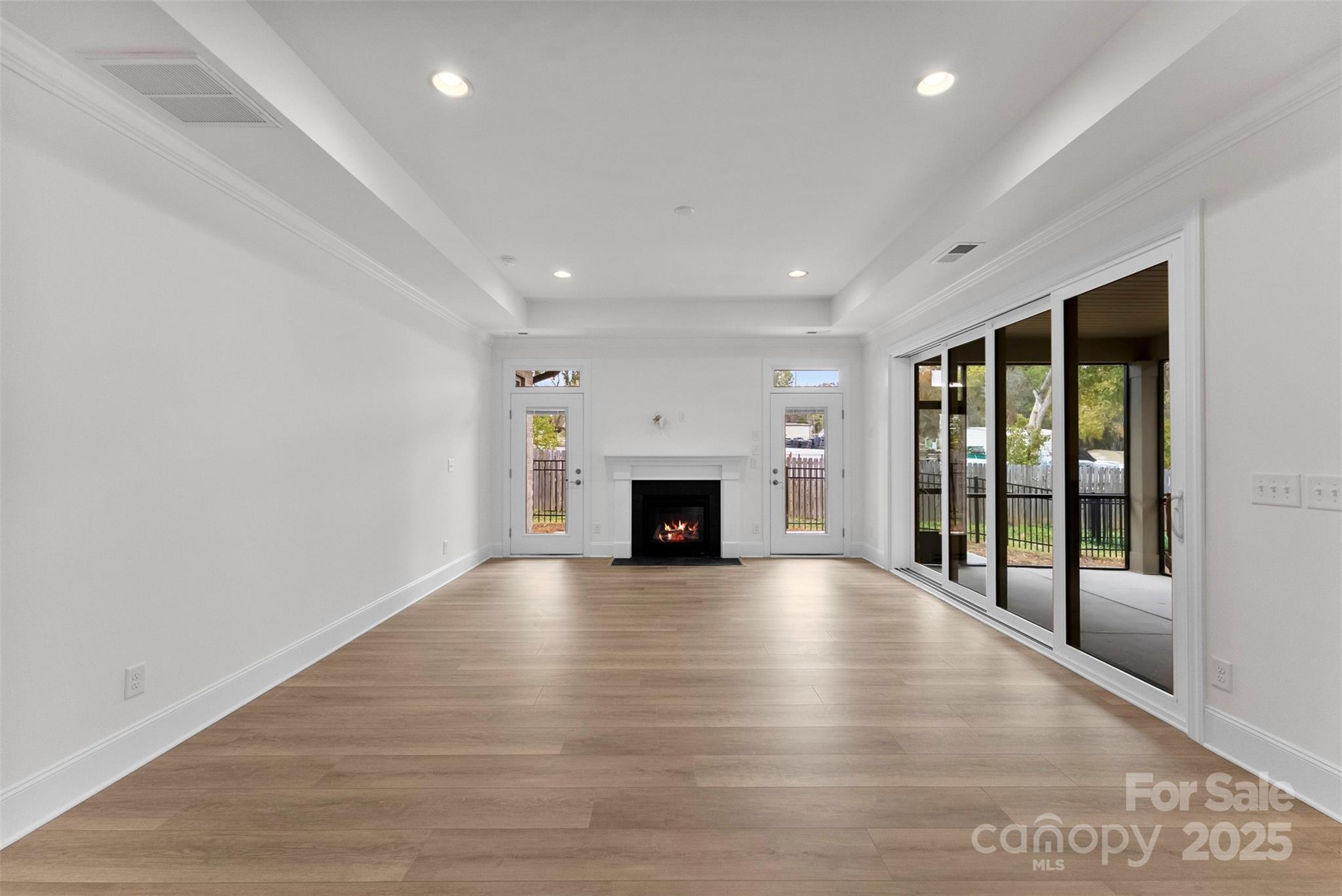 415 Newstyle Way Gastonia, NC 28056 - Photo 8 of 26 a view of an empty room with wooden floor and a fireplace