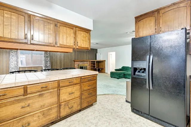 a view of kitchen with microwave and cabinets